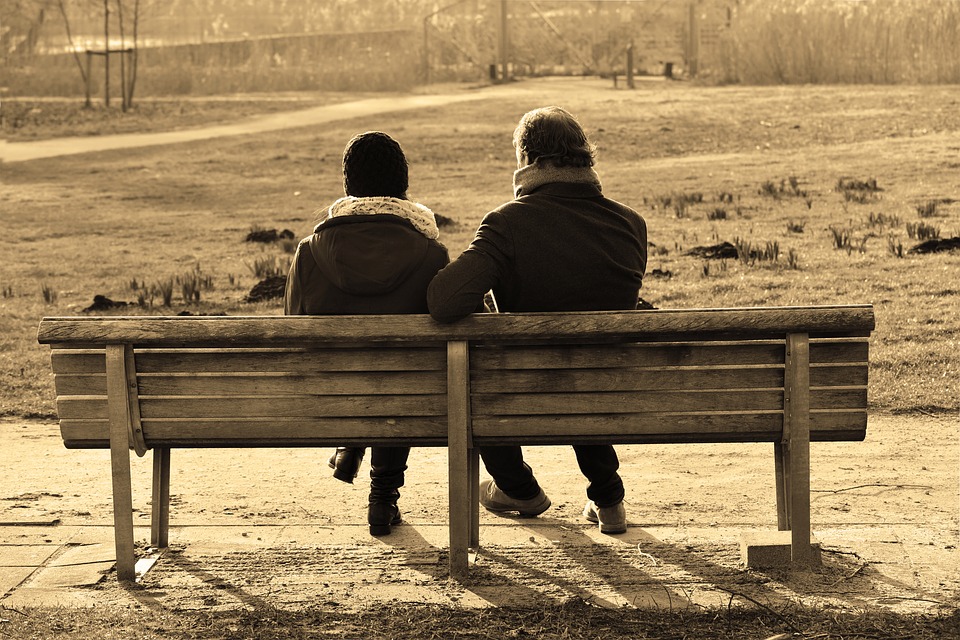 two people sat companionably at a bench.