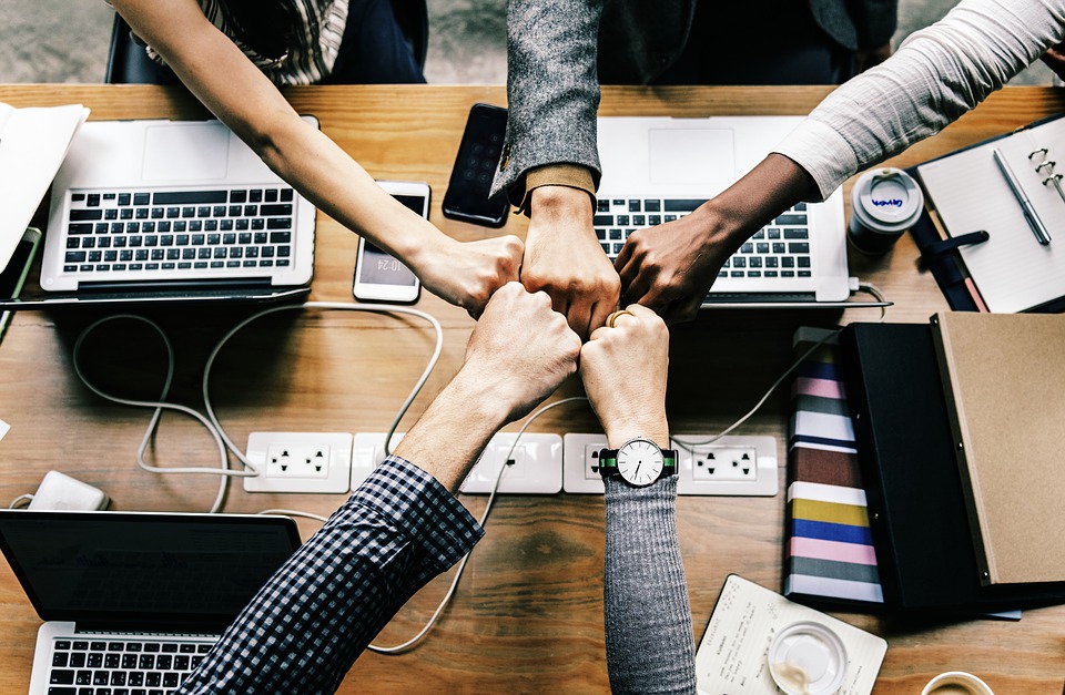 group bringing their hands together to make a connection.